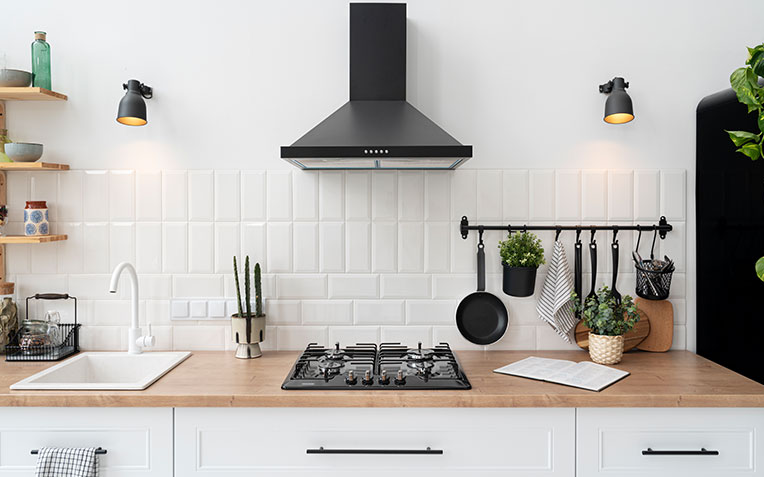 Modern, sleek kitchen with marble countertops, wood cabinets, and stainless steel appliances for Global Home Improvements' kitchen remodeling services.