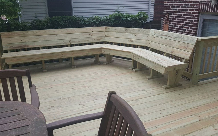 Wooden deck with steps, railing, and planters - ideal for outdoor home improvement projects.