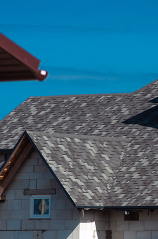 Closeup view of a roofing tile installation, showcasing the quality craftsmanship of Global Home Improvements' roofing services.
