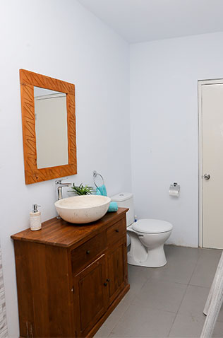 Bathroom with modern vanity, tile flooring, and natural lighting during a home improvement project.