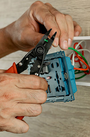 Experienced electrician installing electrical wiring in a home improvement project.