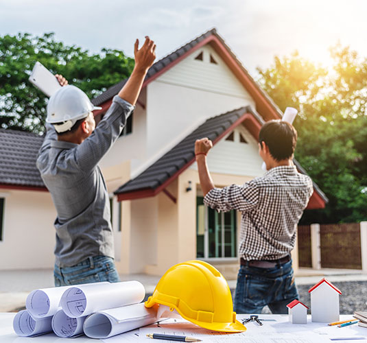 Exterior of modern home with large windows, surrounded by lush greenery - home improvement services