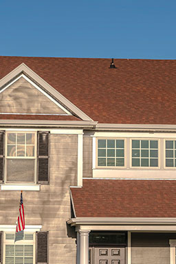Elegant modern home exterior with large windows and landscaping in a Global Home Improvements project.